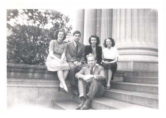 Marion Frieswyk sitting with four other OSS cartographers on some steps.